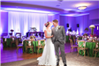Bride and Groom in Grand Ballroom Decorated and Lit in Purple