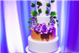 Cake Decorated with Purple Flowers and Green Leaves