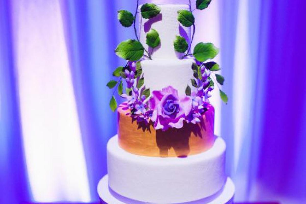 Cake Decorated with Purple Flowers and Green Leaves
