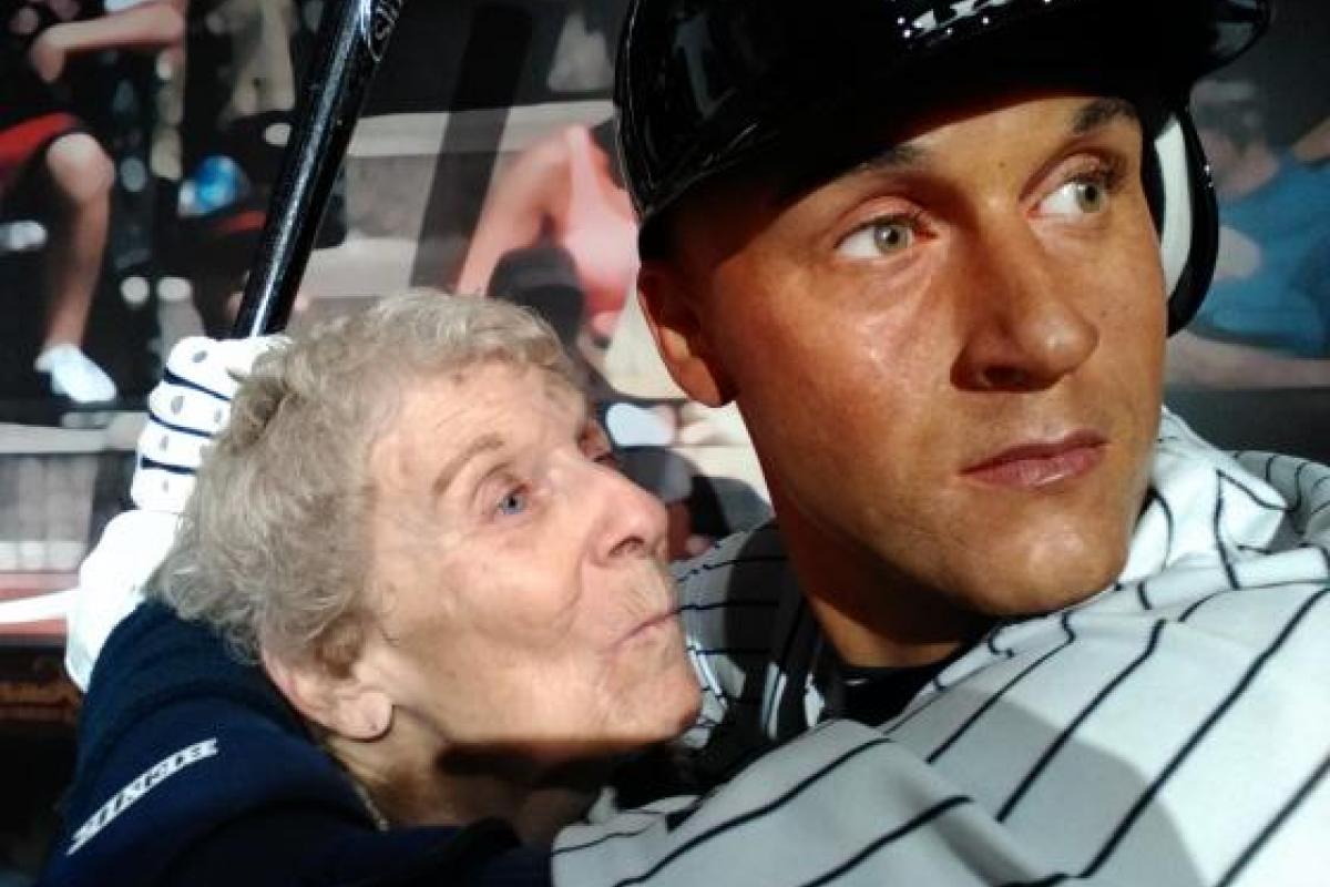 Woman Posing for Photo with Wax Figure of Baseball Player